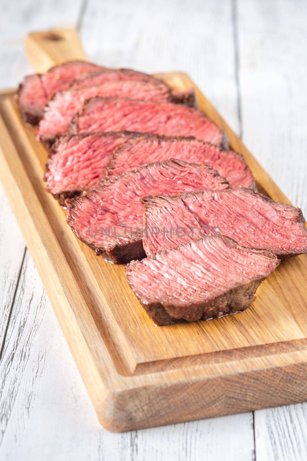 Tender fillet mignon steak, perfectly cooked, sliced, and elegantly presented 