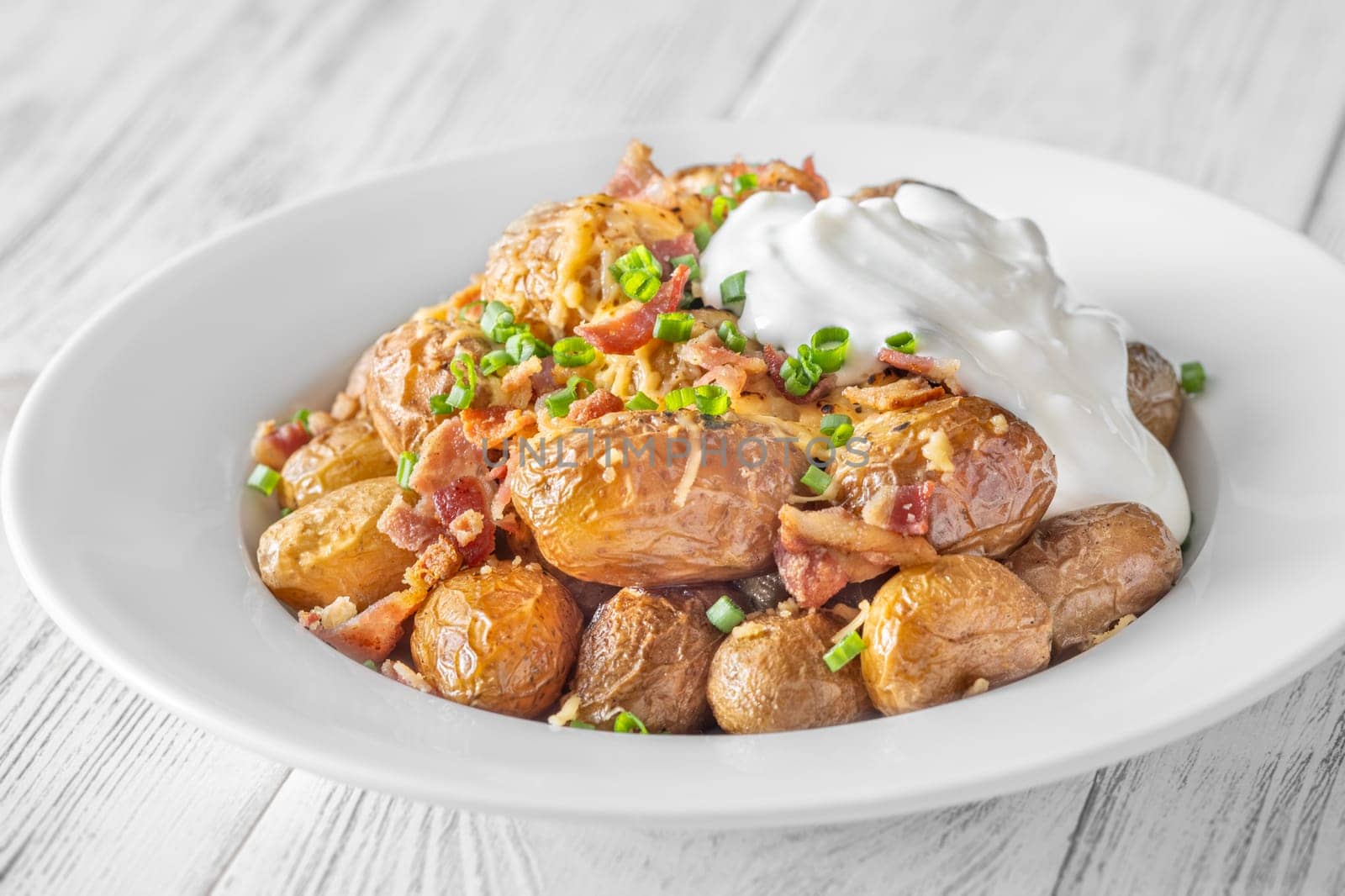 Golden potatoes topped with smoky bacon, gooey cheddar, and fresh green onion