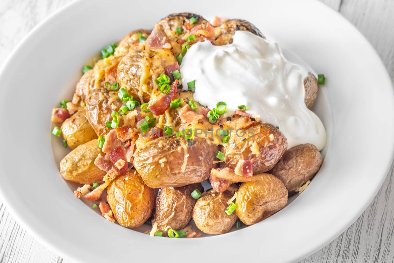 Golden potatoes topped with smoky bacon, gooey cheddar, and fresh green onion