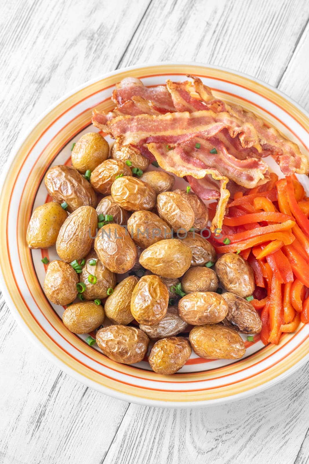 Golden potatoes, smoky bacon, and roasted peppers create a savory, flavorful dish