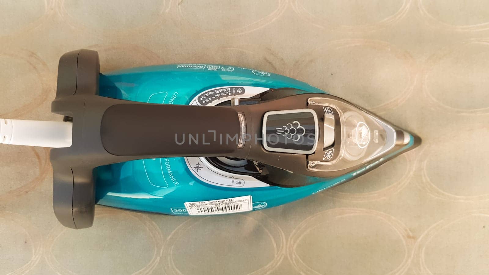 Ukraine, Kiev - May 09, 2020: Blue electric iron on an ironing board on the street