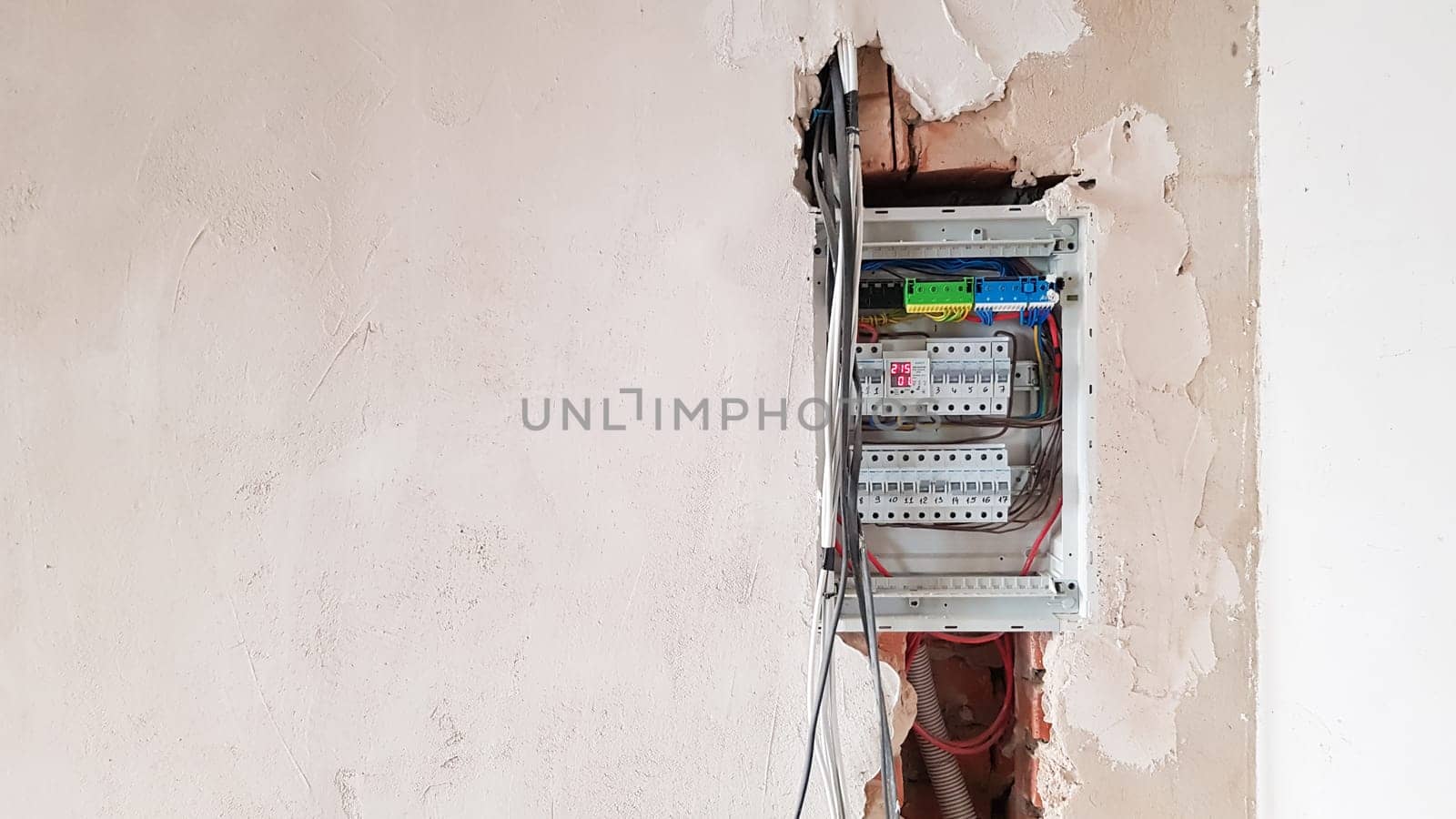 Electrical safety in homes, switchboard panel with switches. Home electrical system in the apartment under repair. Circuit breakers with wires in an electric screen with copy space