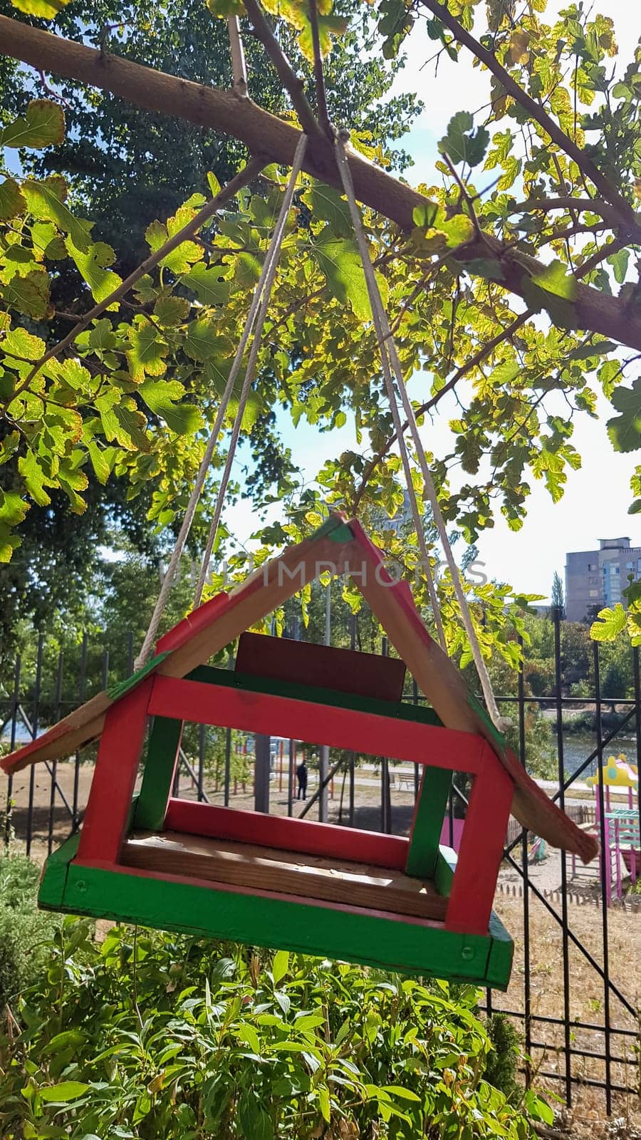 Handmade bird feeders made of wood in a city park. Bird house