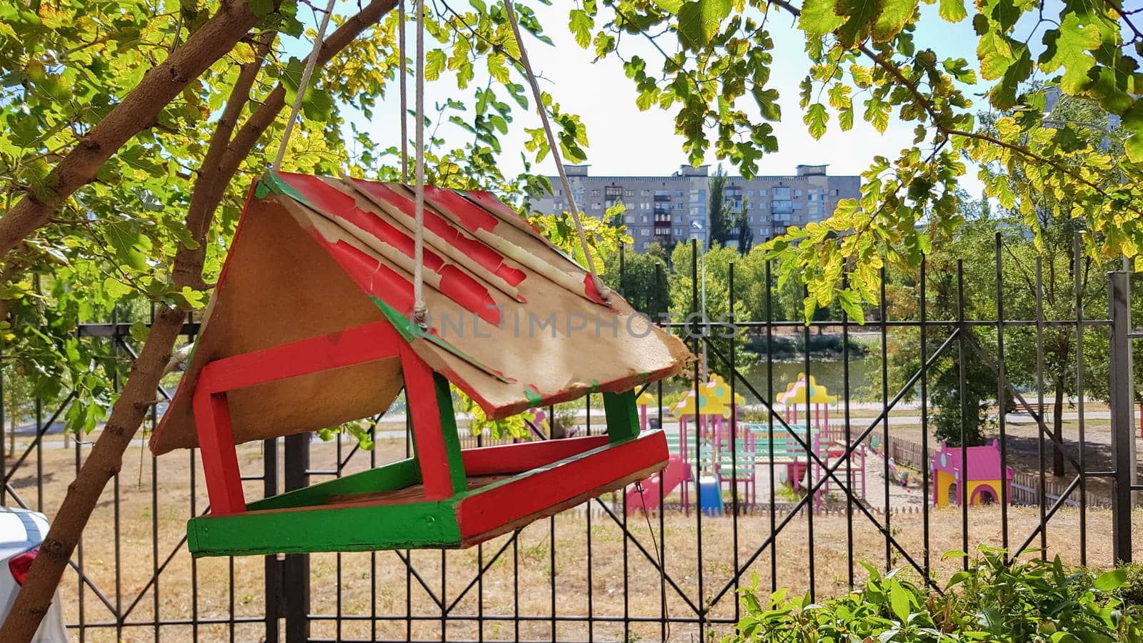 Handmade bird feeders made of wood in a city park. Bird house