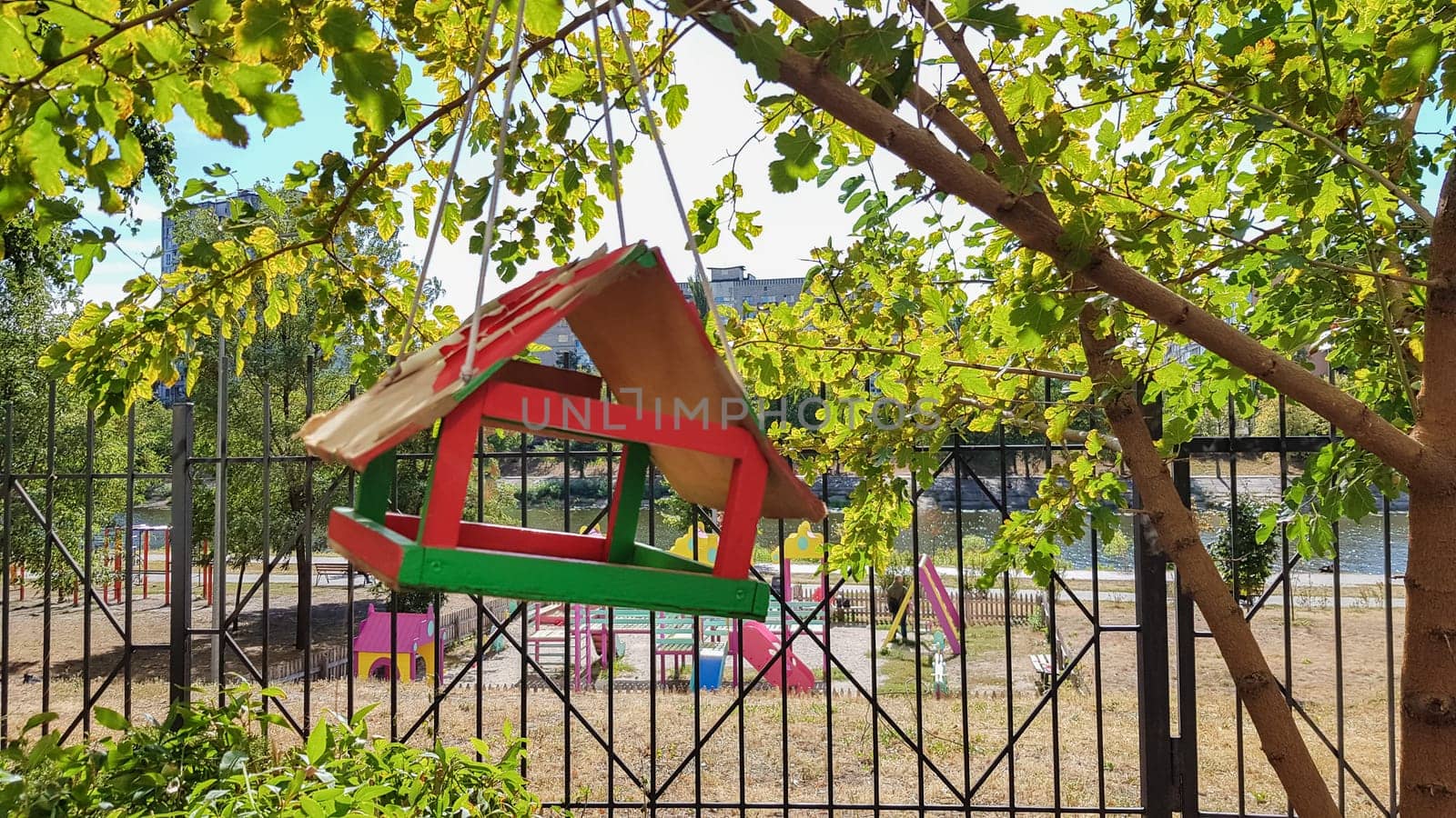 Handmade bird feeders made of wood in a city park. Bird house