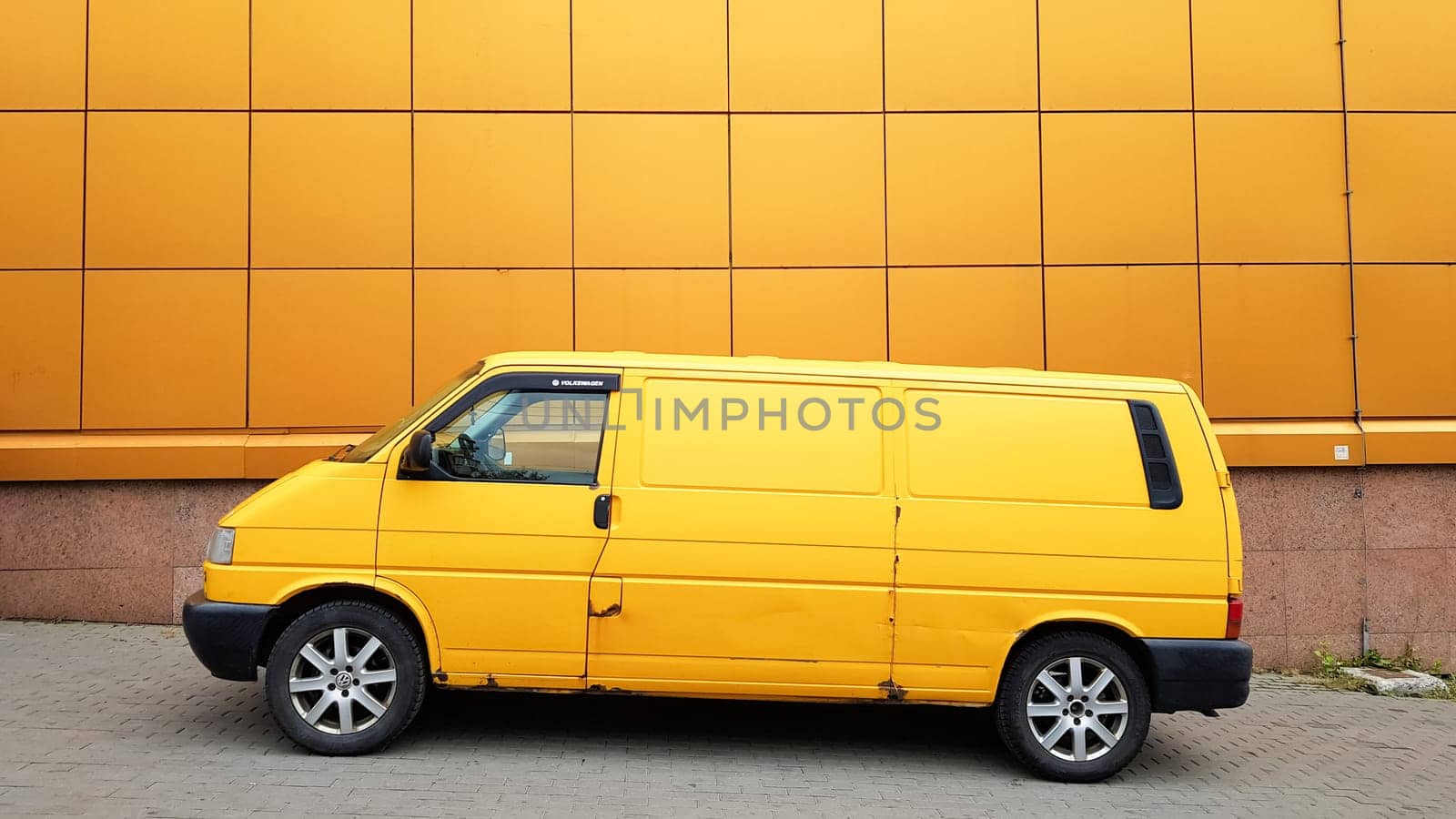 Ukraine, Kiev - March 27, 2020: Yellow Transporter in yellow on a background of a yellow building