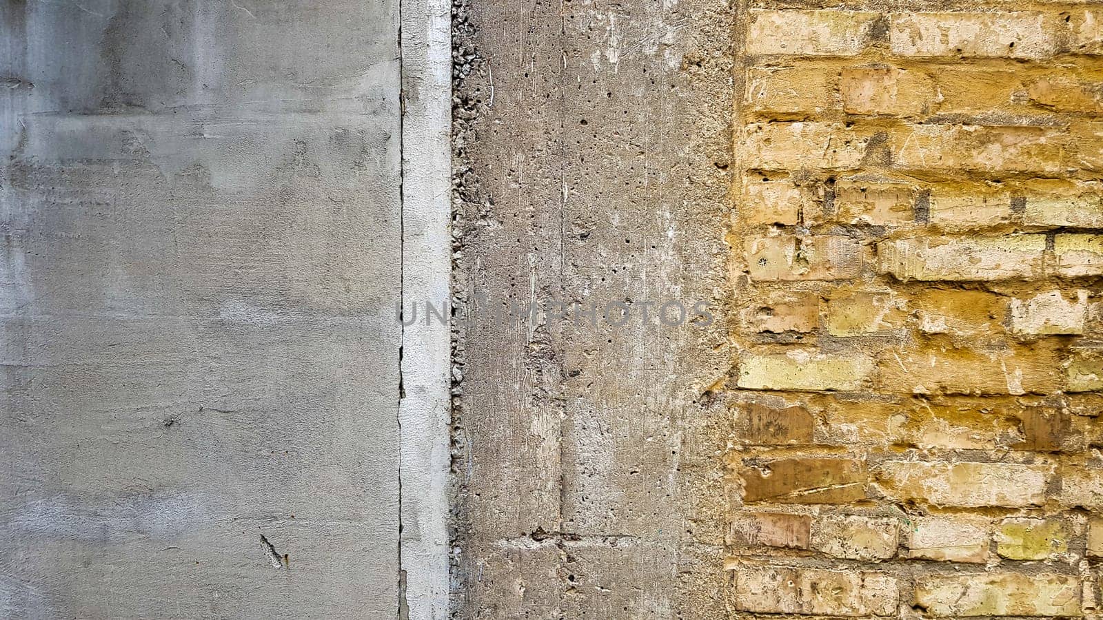 Empty old brick wall texture. Painted problem wall surface. Grunge wide brick wall. Grunge red stone wall background. Shabby building facade with damaged stucco. Copy space