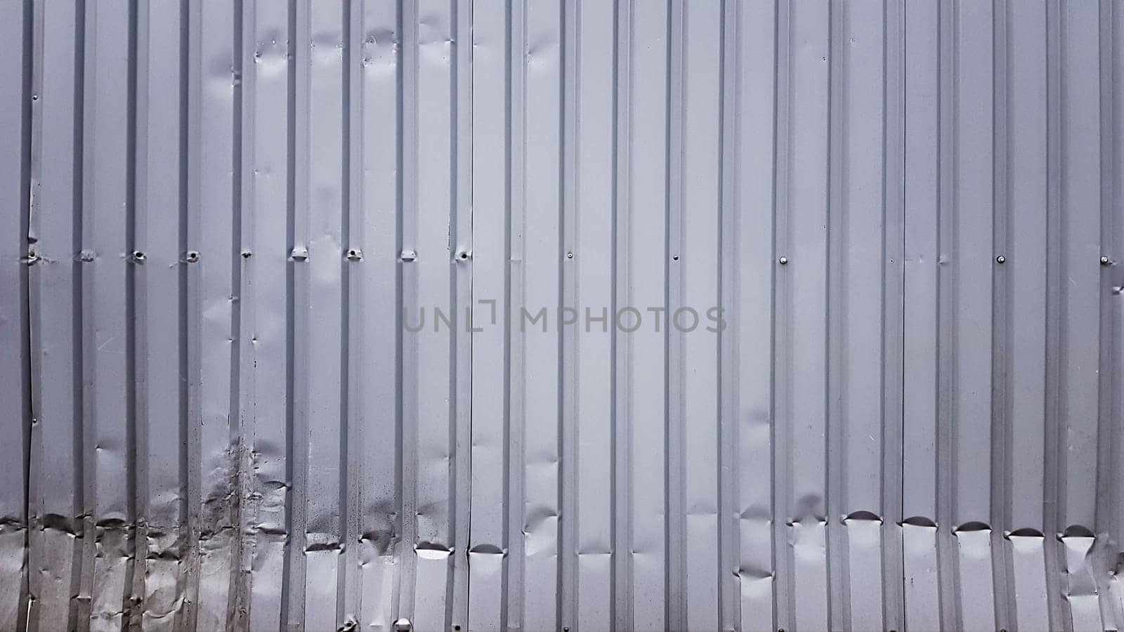 Old zinc abstract. Zinc vintage background view. crumpled metal plate of the fence. Tin roof background with a hole of rust and nails vintage style. Zinc wall surface detail with holes