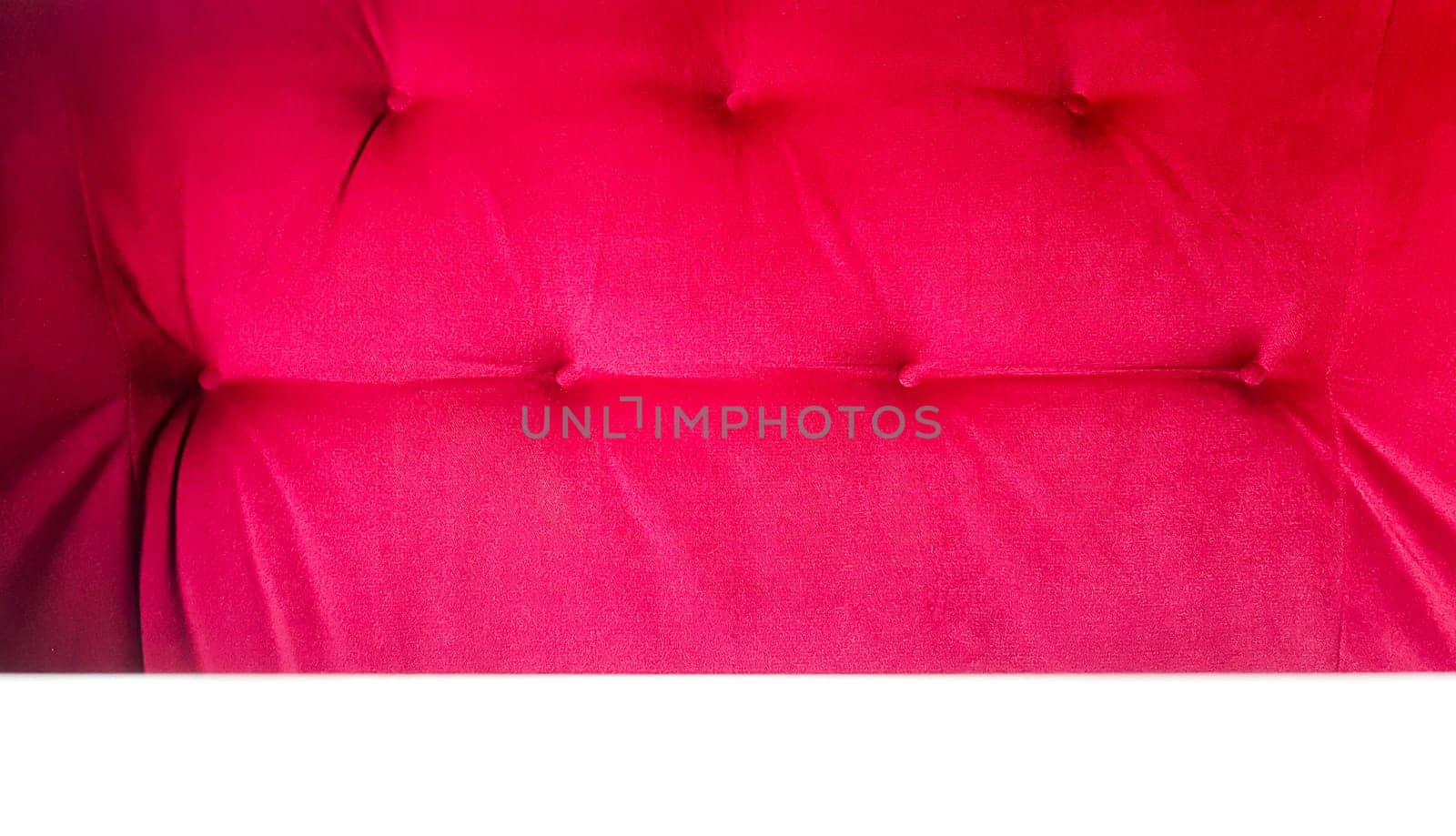 back of a red sofa. Red fabric texture background, Chesterfield style decoration with buttons, retro fabric. Retro diamond-shaped soft style fabric decorate with buttons. red velvet background.