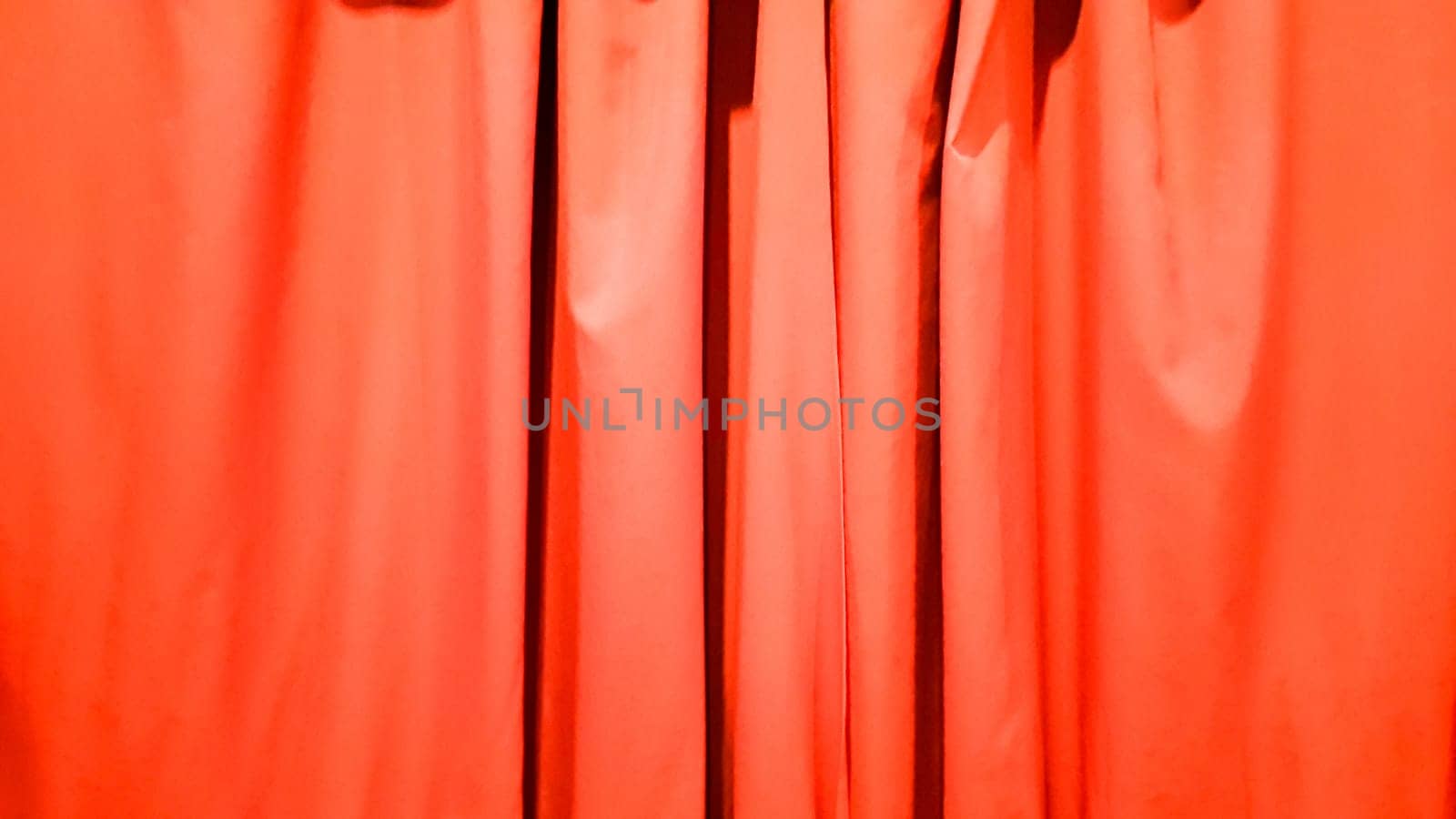 Red curtain use for background. Silk Cloth Background, Red Satin Fabric Waves, Abstract Texture. Red concert curtain full of folds.
