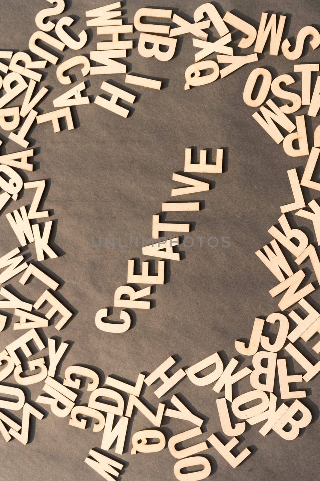 Creative Word In Wooden Cube Alphabet Letters Top View On A rustic paper Background.