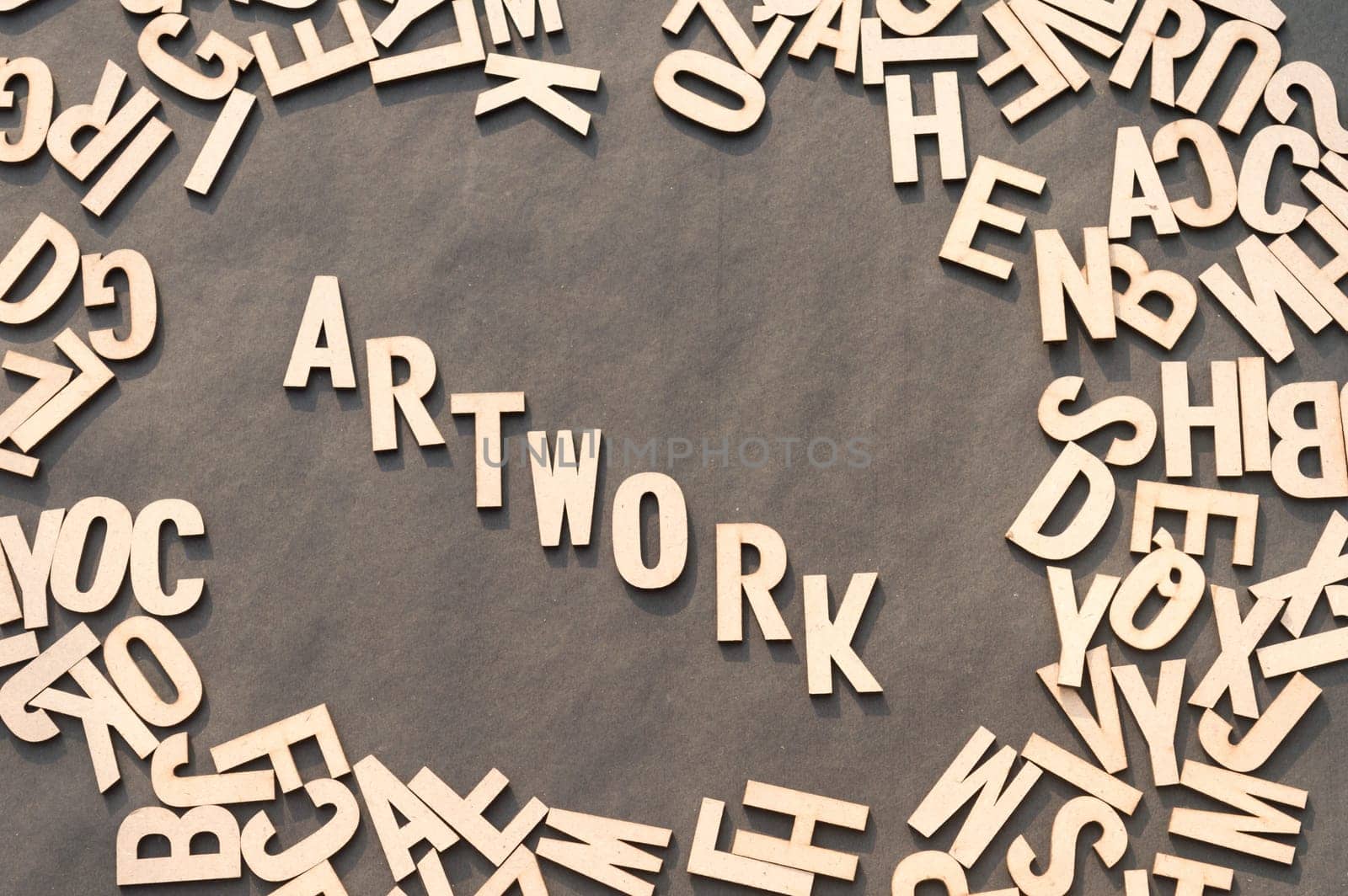 Artwork Word In Wooden Cube Alphabet Letters Top View On A rustic paper Background.
