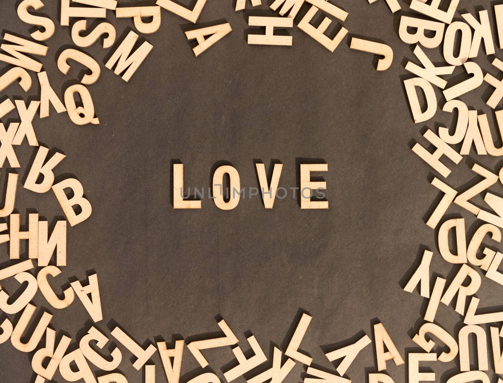 Love Word In Wooden Cube Alphabet Letters Top View On A rustic paper Background.