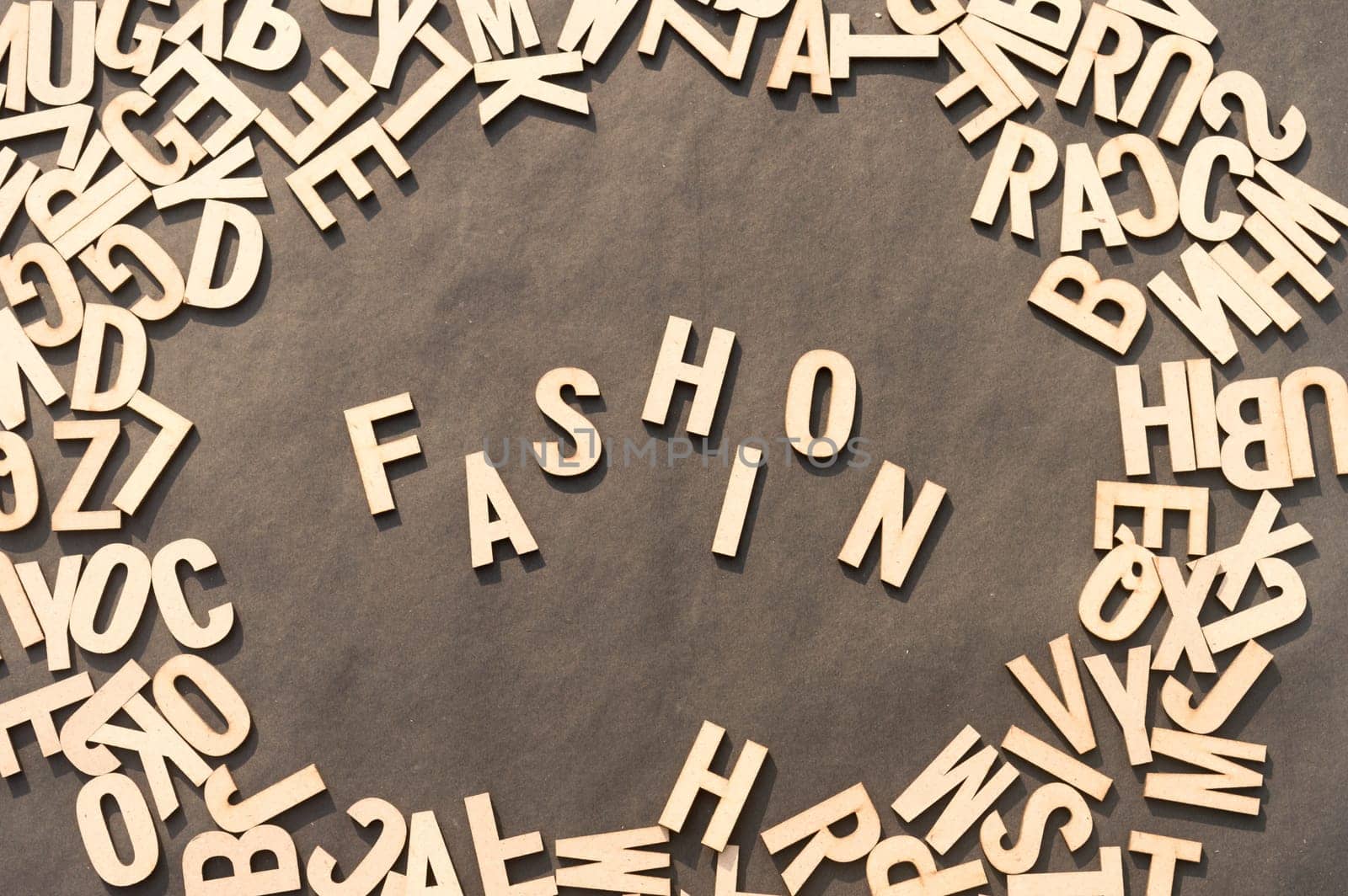 Fashion Word In Wooden Cube Alphabet Letters Top View On A rustic paper Background.
