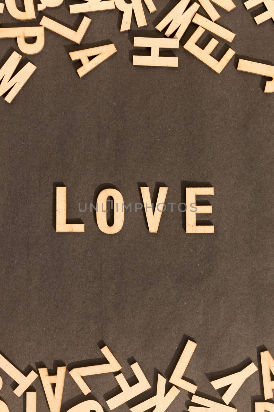 Love Word In Wooden Cube Alphabet Letters Top View On A rustic paper Background.