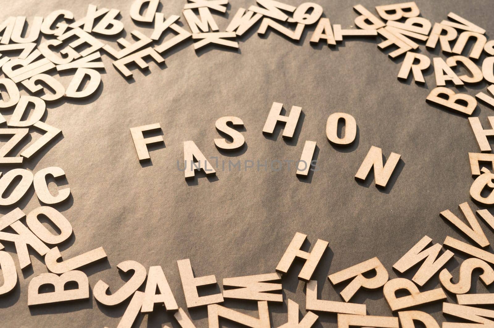 Fashion Word In Wooden Cube Alphabet Letters Top View On A rustic paper Background.
