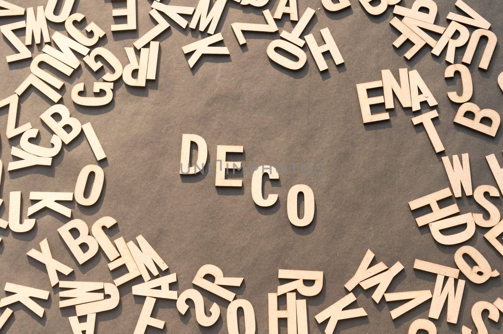 Deco Word In Wooden Cube Alphabet Letters Top View On A rustic paper Background.