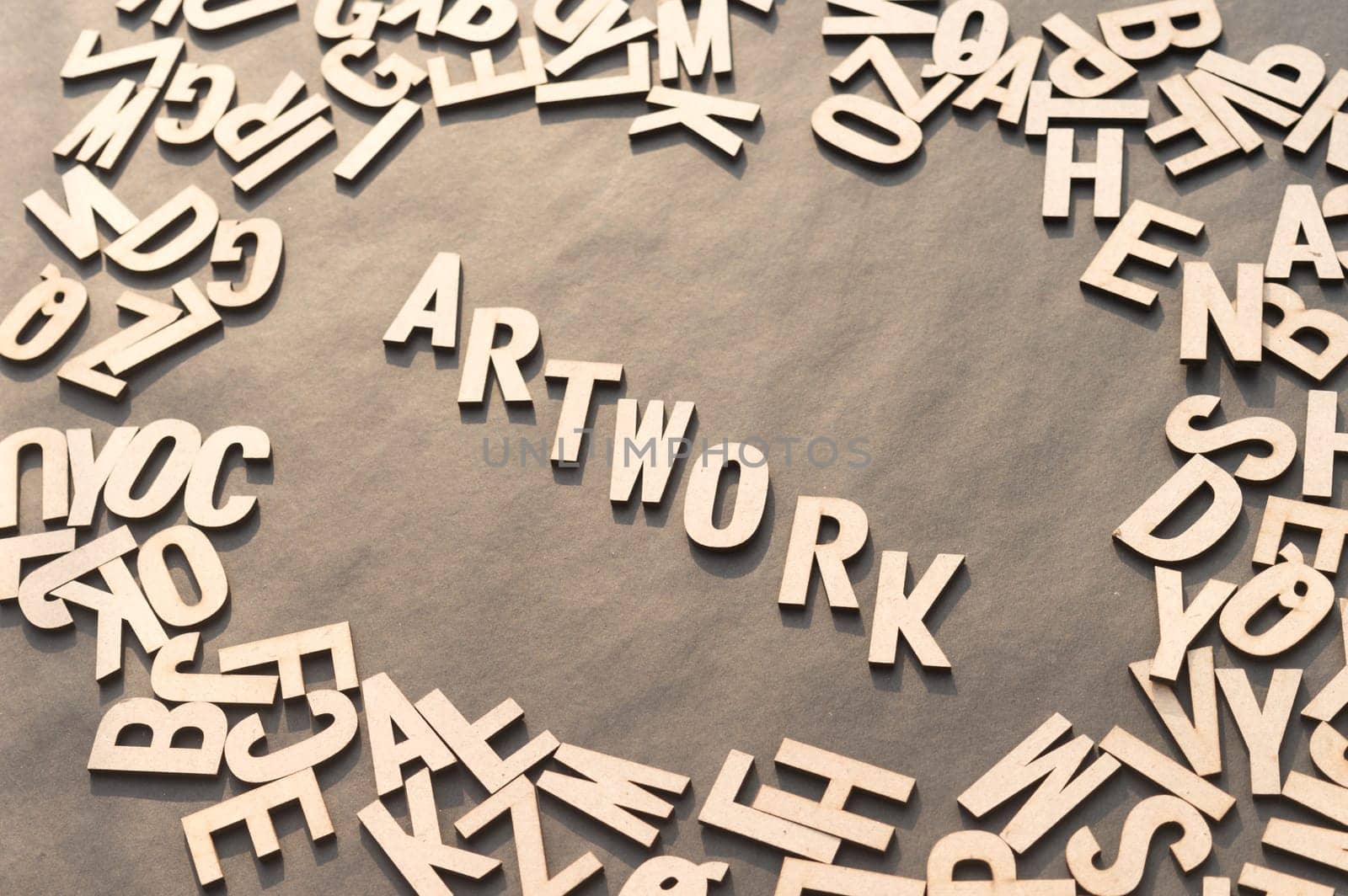 Artwork Word In Wooden Cube Alphabet Letters Top View On A rustic paper Background.