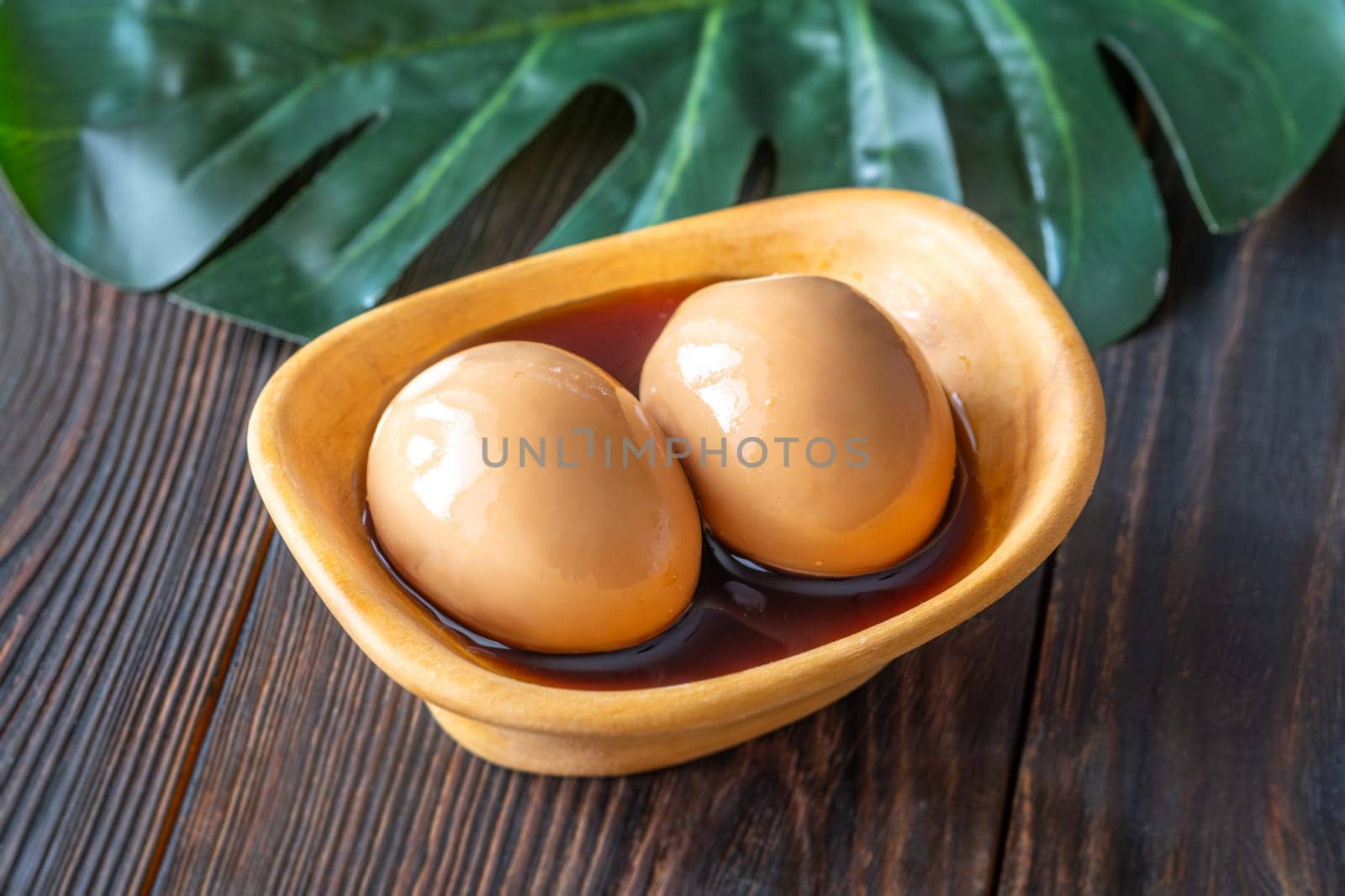 Soft-boiled ramen eggs soaked in savory marinade, garnished with sesame seeds