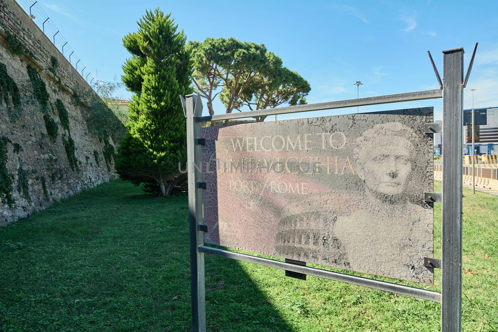 Civitavecchia, Italy - February 02, 2025: A vintage welcome sign with cracks and faded text, symbolizing the passage of time in a historic trade city. Concept: maritime, history, time