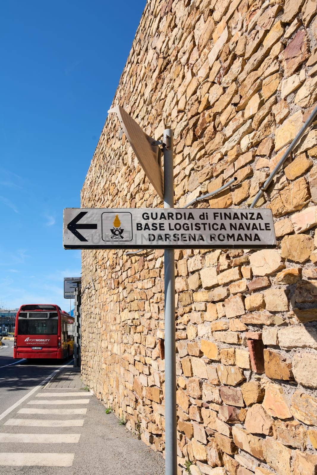Civitavecchia. Italy - February 02, 2025: Signboard indicating the naval logistic base of Guardia di Finanza at the Roman Dock. The image shows the official sign with clear text and symbols.