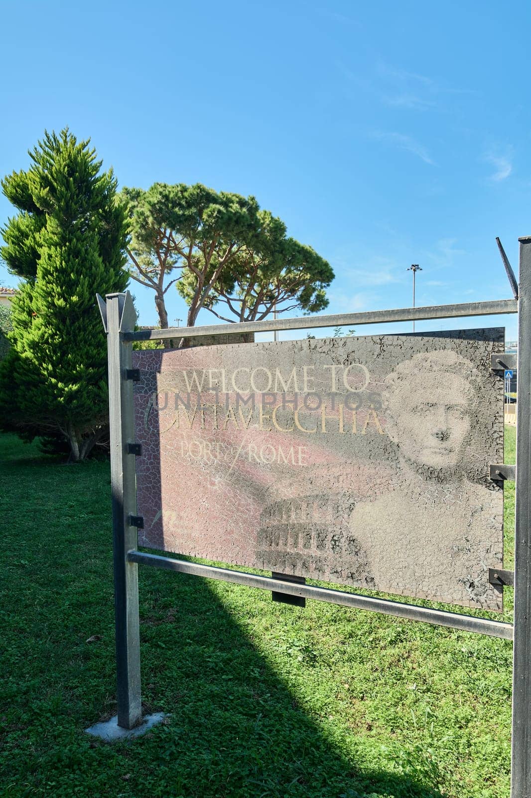 Civitavecchia, Italy - February 02, 2025: A rustic sign welcoming visitors to the port of Rome, showing signs of wear and age. Concept: entrance, tourism, decay