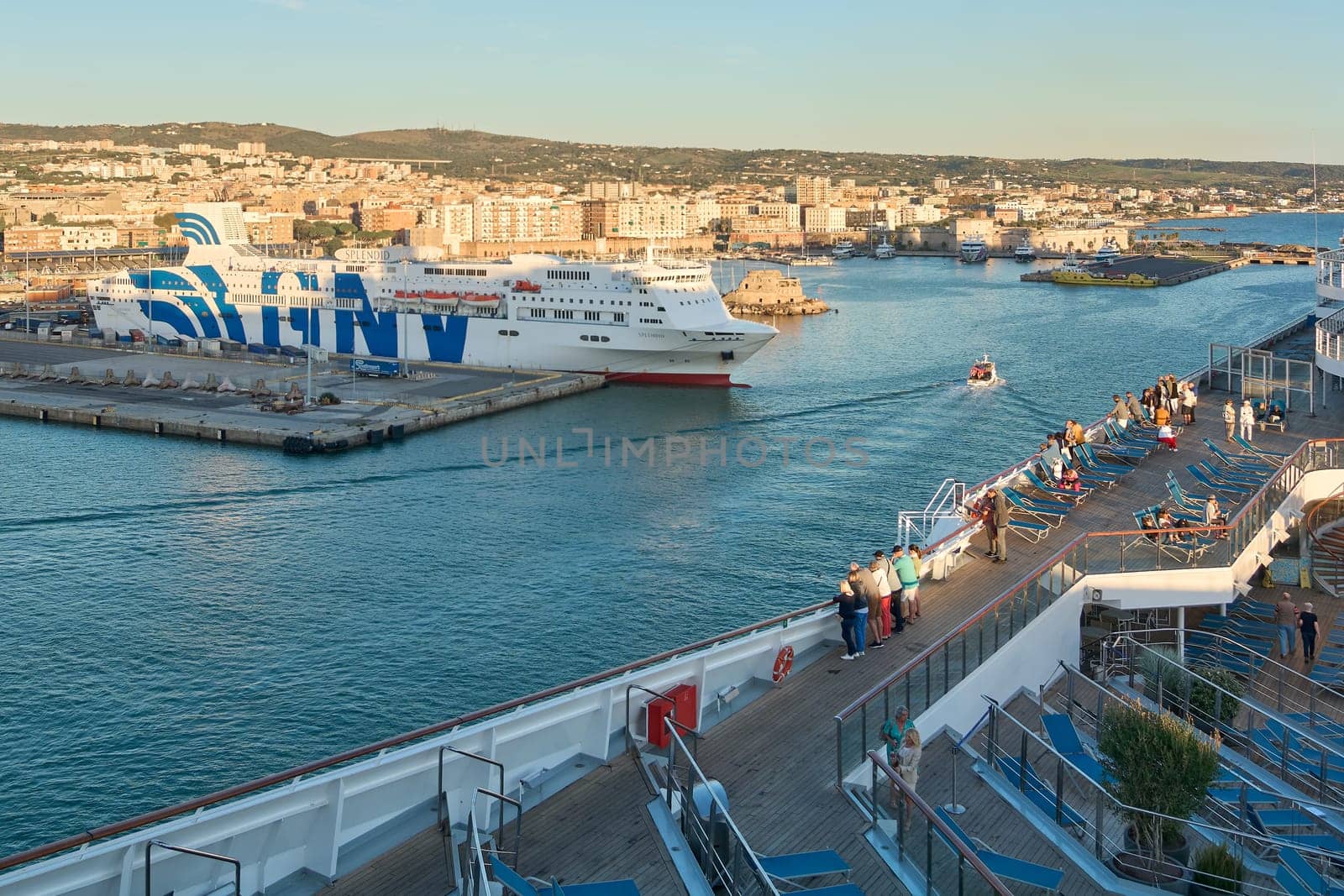 Civitavecchia, Italy - February 02, 2025: Industrial port scene with a docked ferry, cargo trucks and loading areas, reflecting Italy's maritime trade. Concept: industrial, export, cargo.