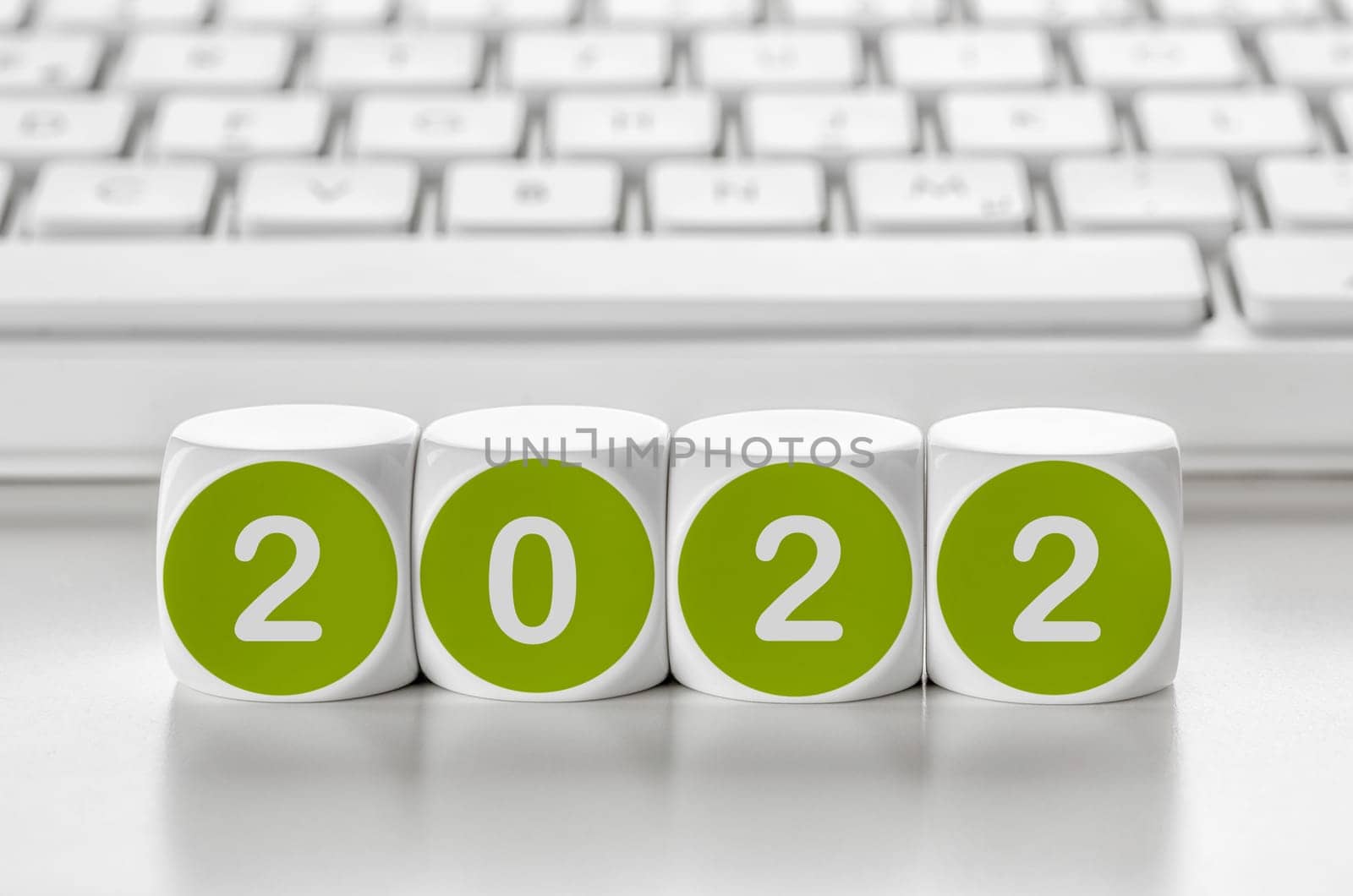 Letter dice in front of a keyboard - 2022