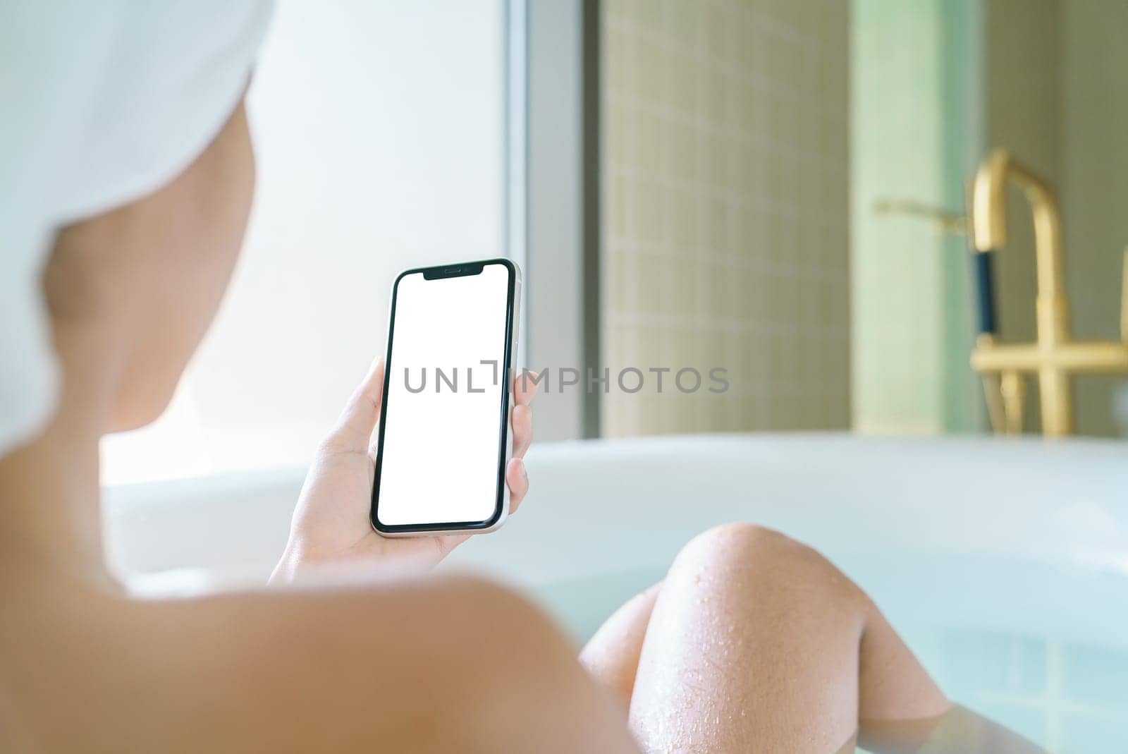 phone blank screen display in woman hand, relax in bathtub with smartphone in morning time