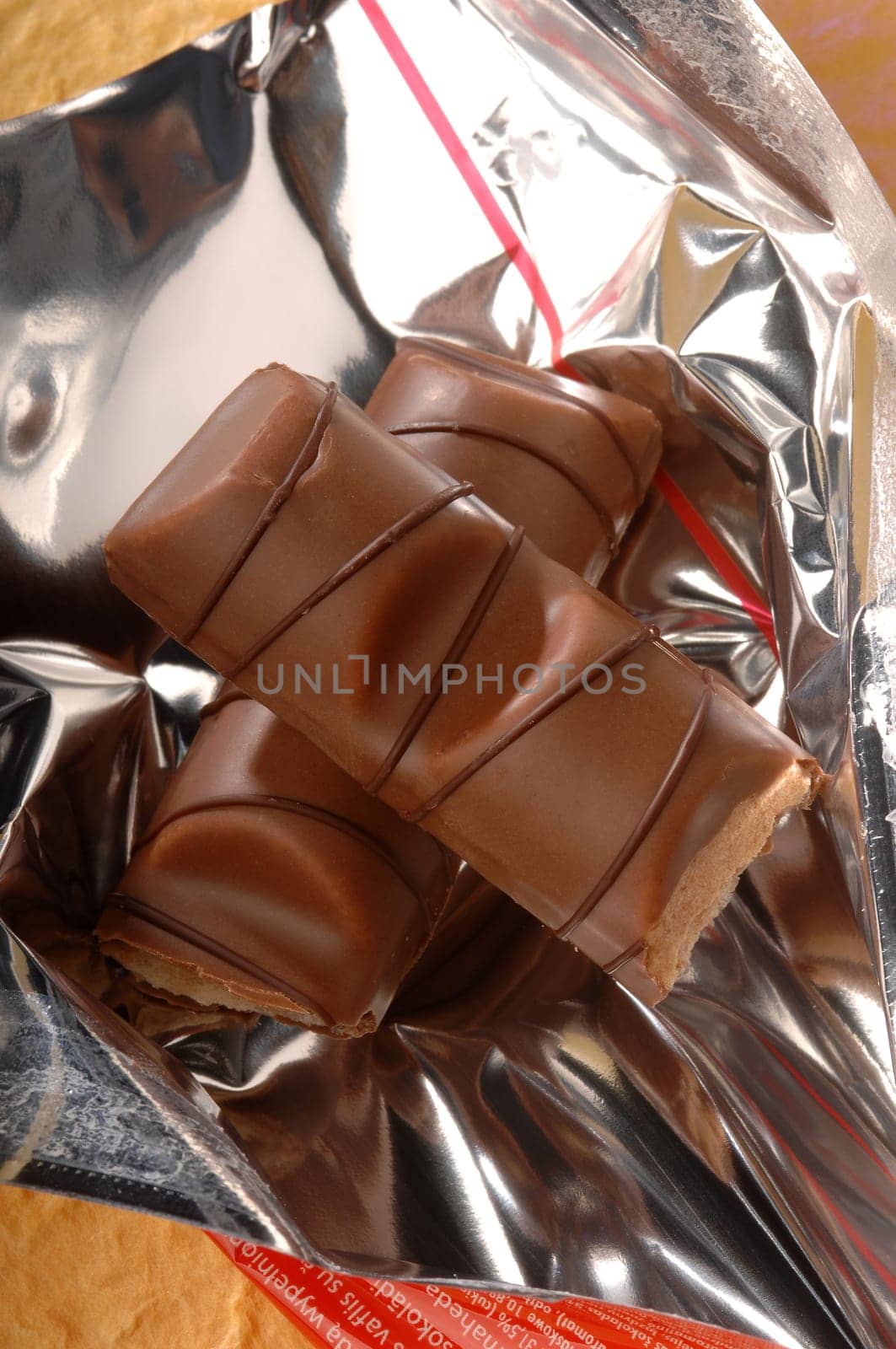 a chocolate bar with a filling on a yellow background
