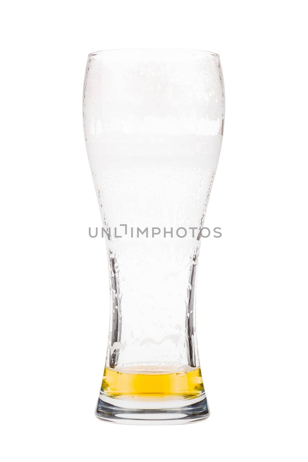 Tall beer glass almost full with lager beer, in the process of drinking. Someone already took a sip from the glass. Isolated on white
