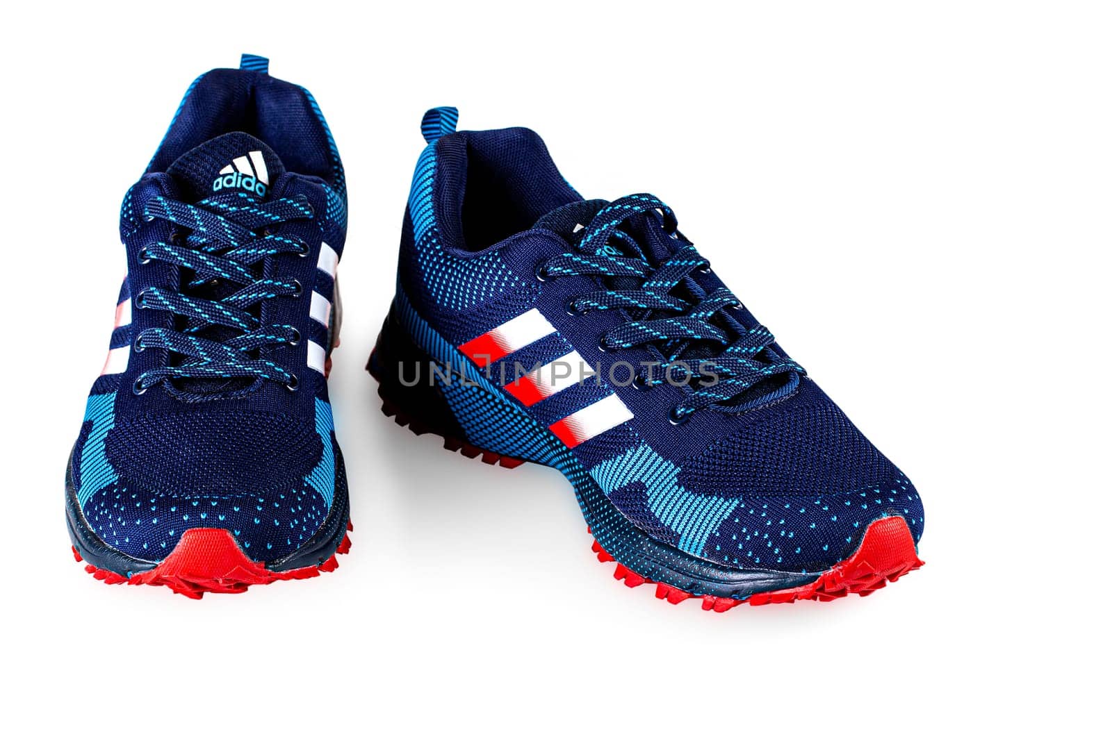 Kamchatka, Russia - September 22, 2021: Blue Adidas Running Sneakers. Adidas, Germany company. Isolated on white.