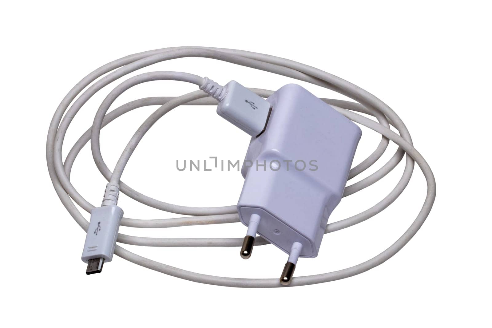 Closeup of a adapter charger with USB cable with Micro USB isolated on a white background. Macro photograph of a Smartphone or iphone battery charger.