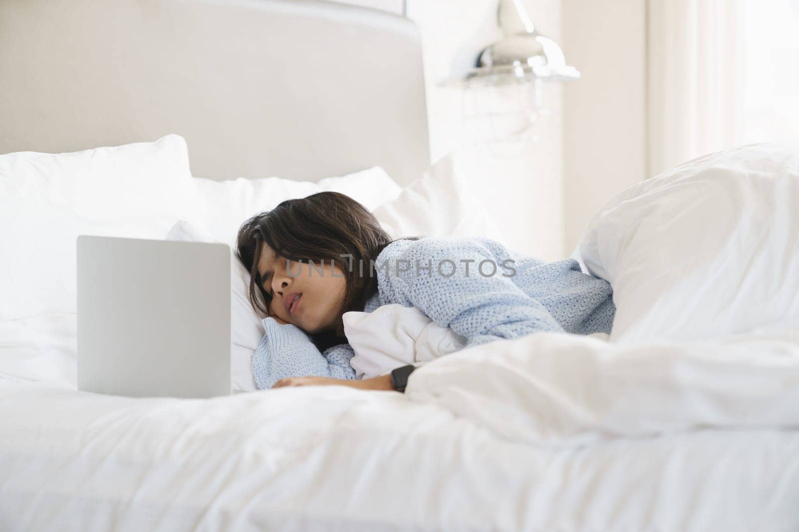 woman sleeping after use computer overwork on bed