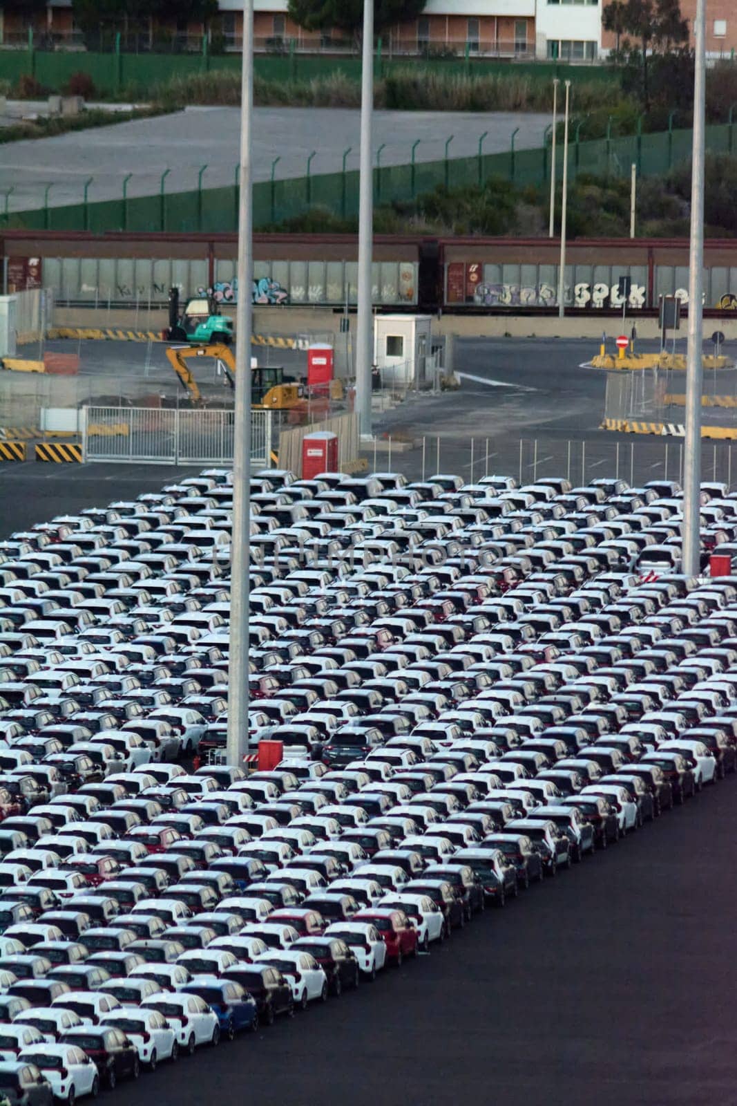 Civitavecchia, Italy - February 7, 2025: Rows of new cars ready to be exported. Represents the automotive industry and global trade. Essential for vehicle distribution networks.