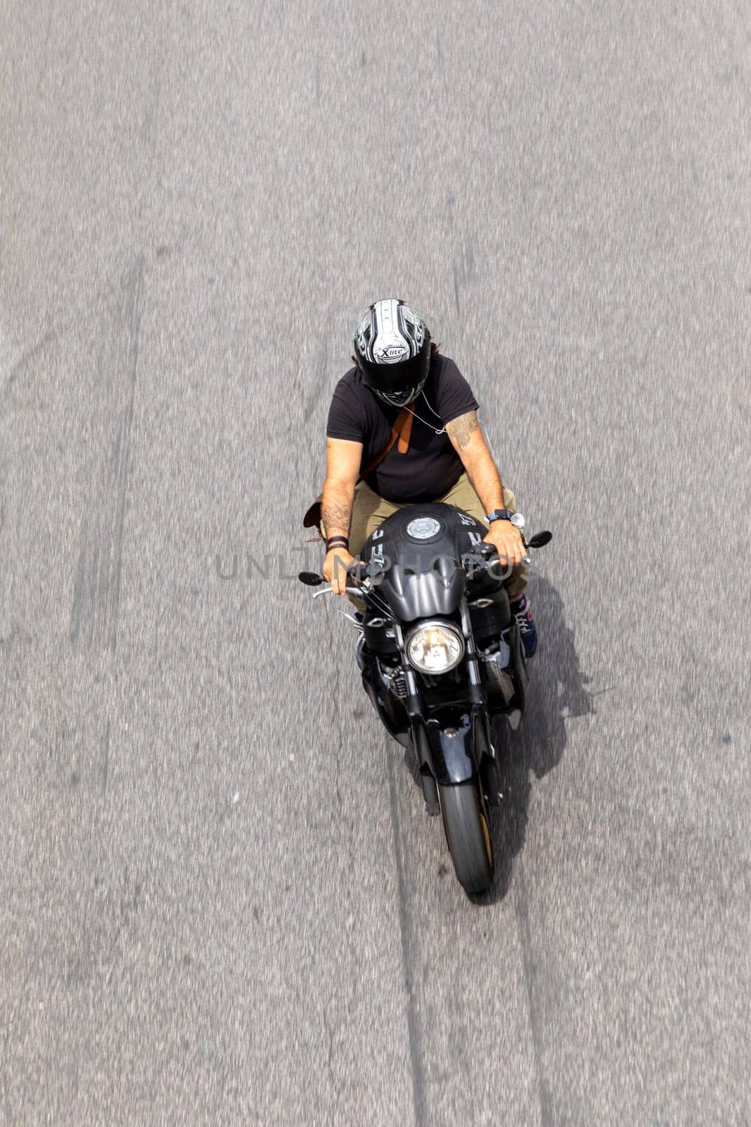 Rome, Italy - August 4, 2021: people on Motorbike in Rome in areal view. Many people in Rome use Motorbikes to avoid traffic jam.