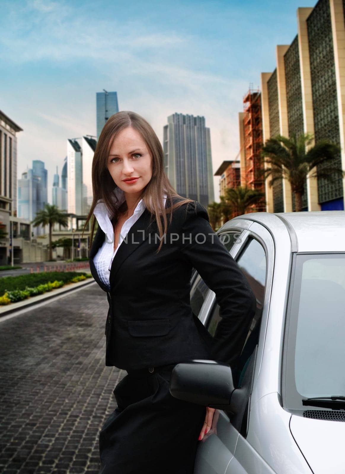Beautiful business woman standing near her car