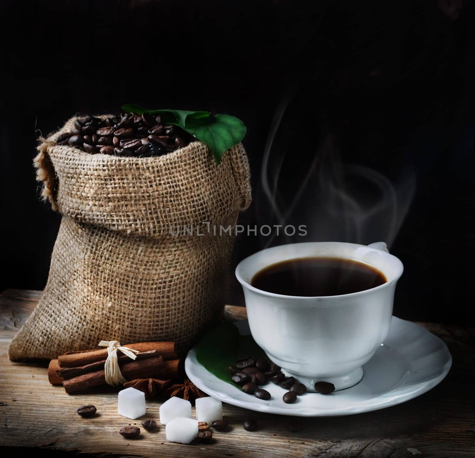 Coffee concept with coffee beans and fresh coffee leaves