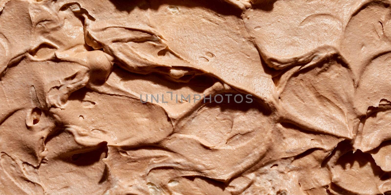 Background texture of the surface of creamy caramel or toffee ice cream in a wide angle panorama for menu, product or catering advertising