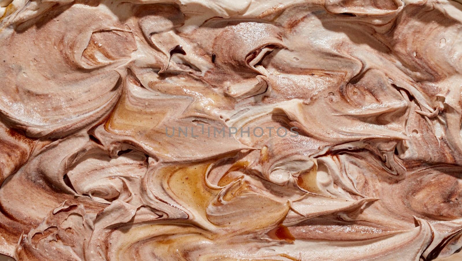 Delicious handmade speciality coffee or chocolate ice cream with a swirled ridged texture in a close up full frame background for menu advertising