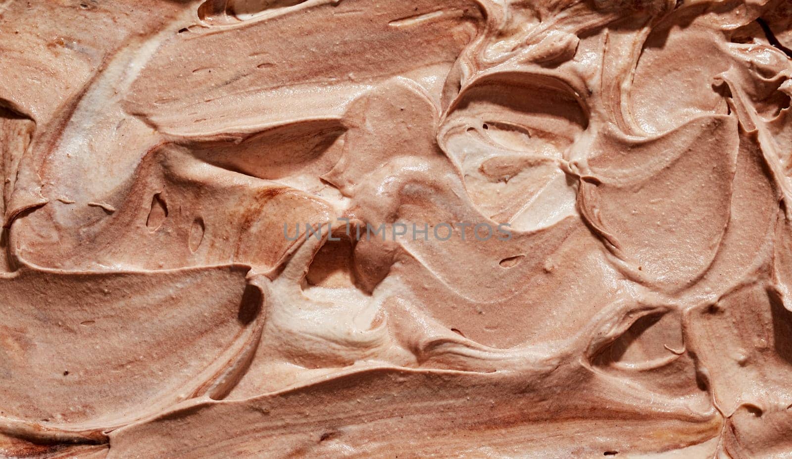 Tasty homemade or craft chocolate or caramel ice cream in a close up background texture for a design template or advertising in a full frame view