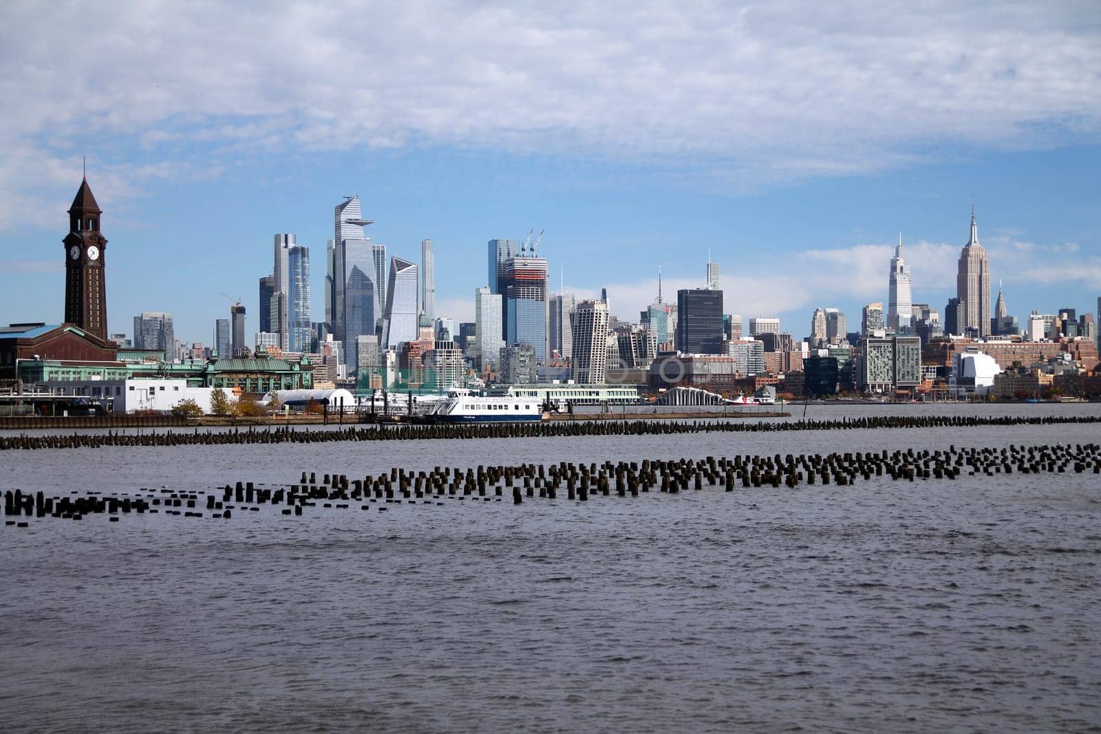 Midtown Manhattan and Hoboken train station with the Hudson river in the middle from Jersey City