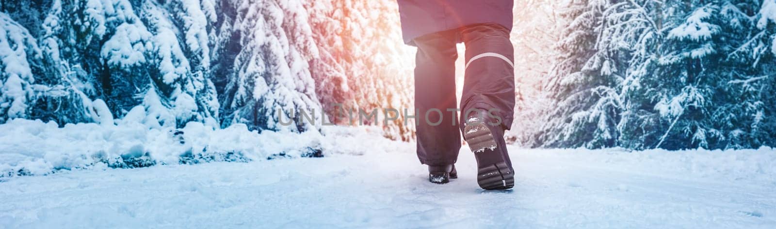 Loneliness woman walking in the winter forest. Beautiful natural park after snowfall. Concept of recreation and vacation.