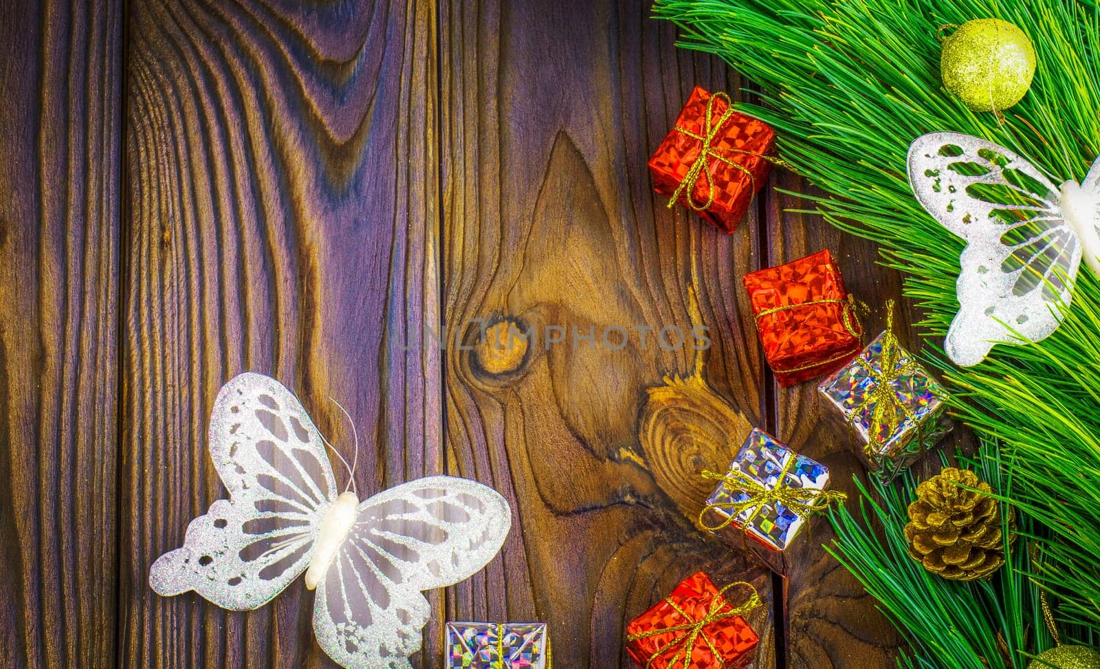 The fir-tree with toys, white butterfly and gifts. Background. Selective focus