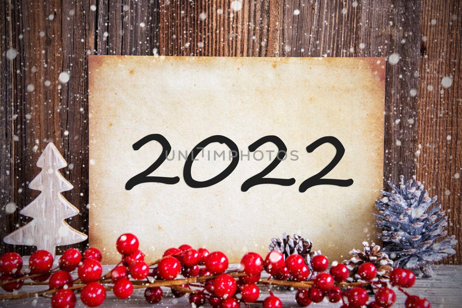 Paper With Text 2022 For Happy New Year Greetings. Christmas Decoration And Wooden Background With Snow