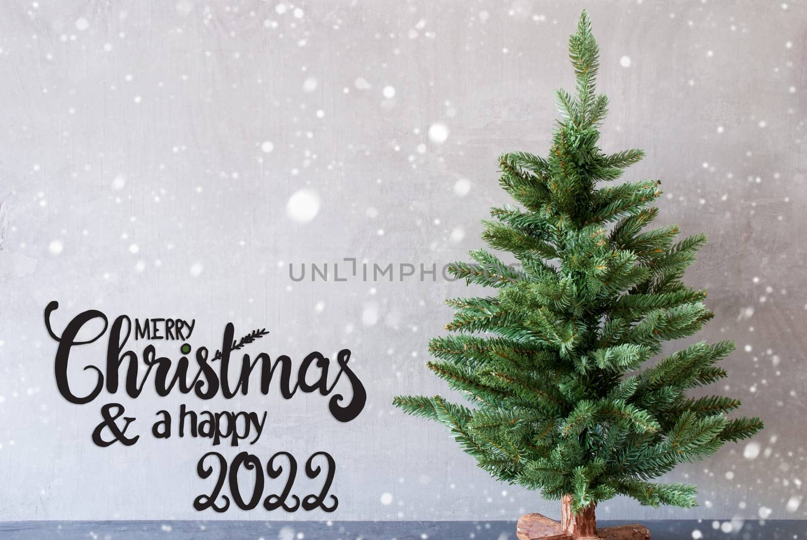 Egnlish Calligraphy Merry Christmas And A Happy 2022. Green Christmas Tree With Gray Concrete Background