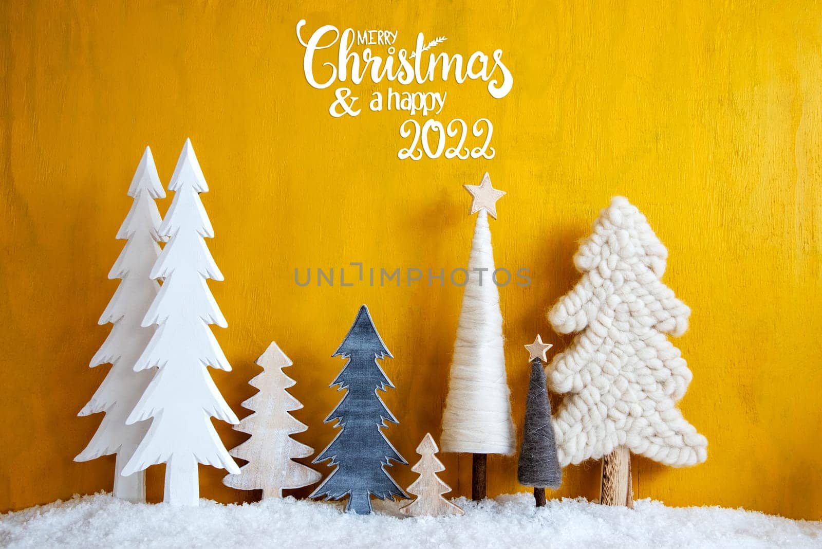 Christmas Trees With English Calligraphy Merry Christmas And A Happy 2022. Yellow Wooden Rustic Background With Snow. Christmas Decoration With Stars.