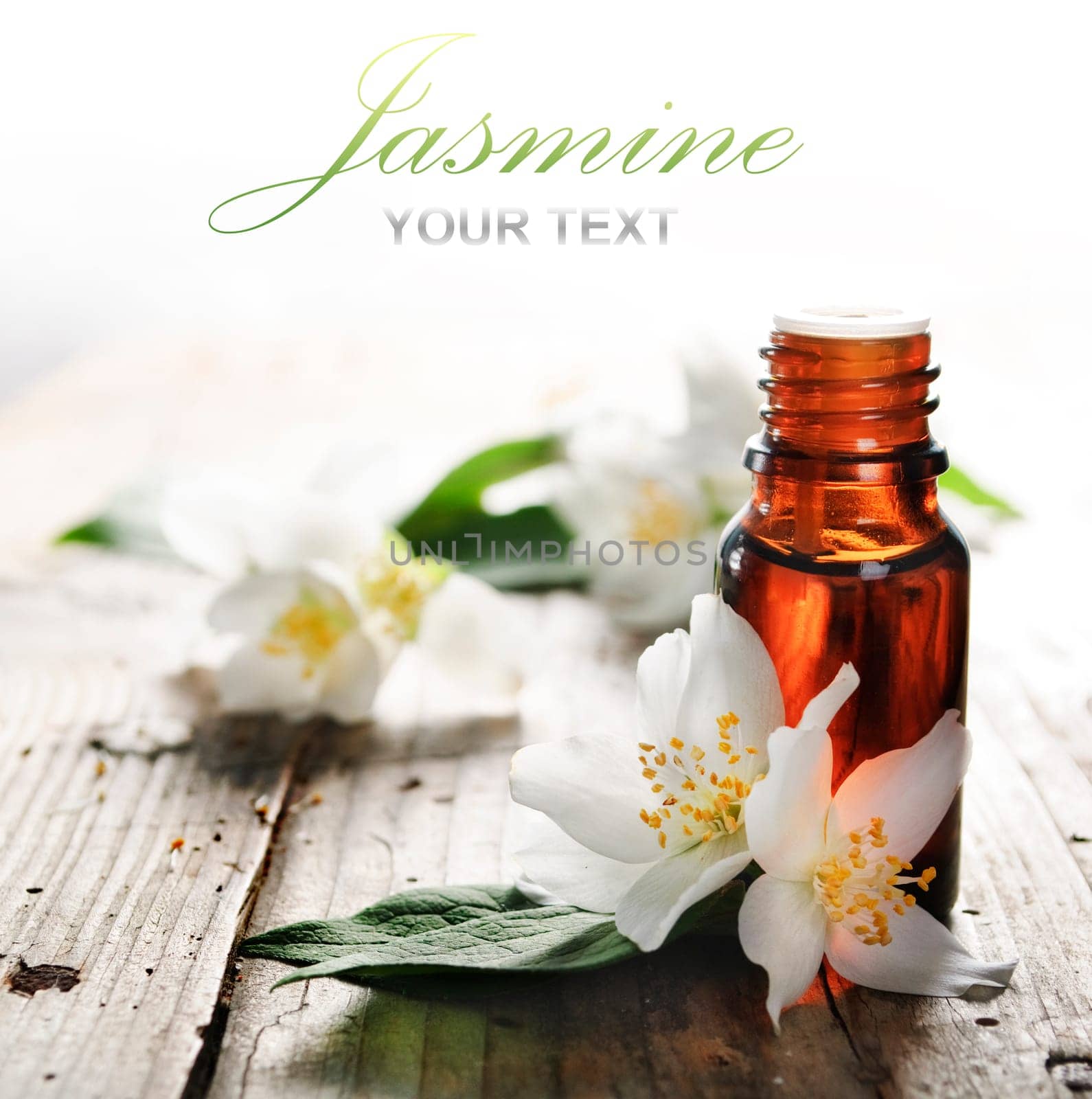 Essential oil with jasmine flower on wooden plank
