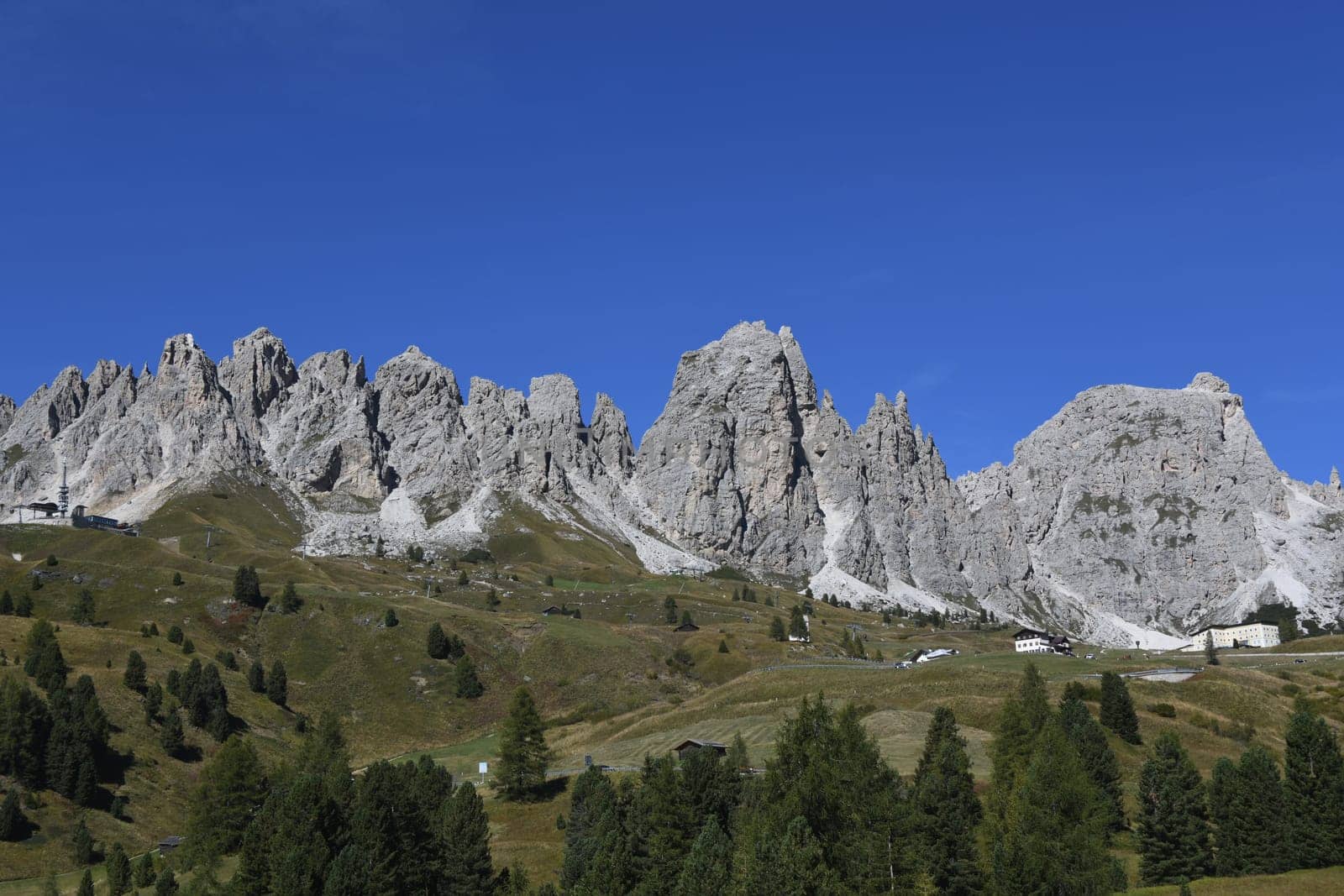 Panoramic view of the Gardena Pass,Gardena Pass and the pass road in the South Tyrolean Dolomites. It connects Val Gardena in Val Badia and the municipalities of Selva,Corvara,Colfosco and Alta Badia in the Alps