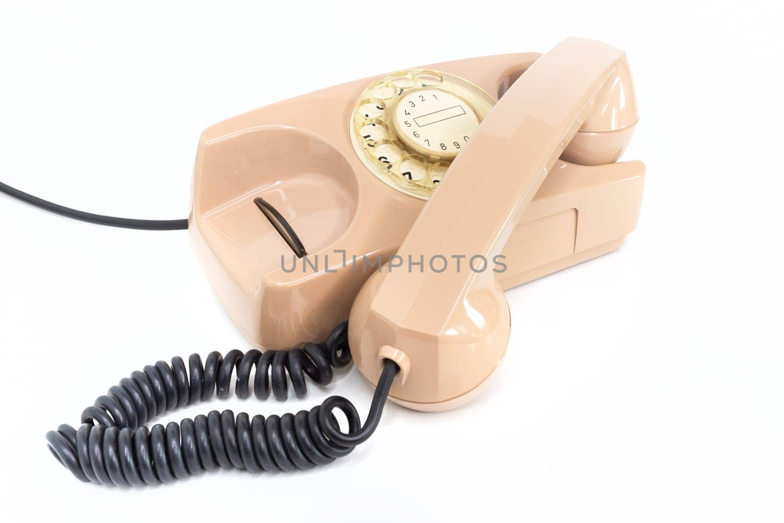 Vintage telephone. Pink old telephone isolated on white background.